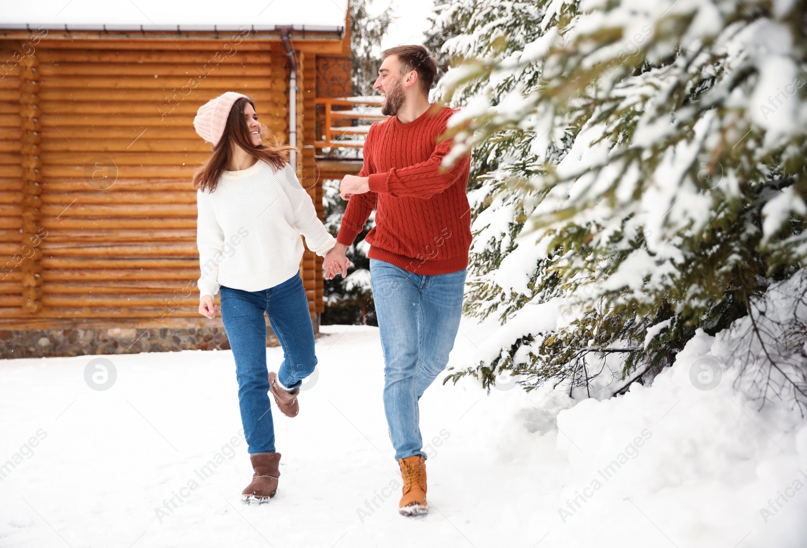 Photo of Lovely couple walking together on snowy day. Winter vacation