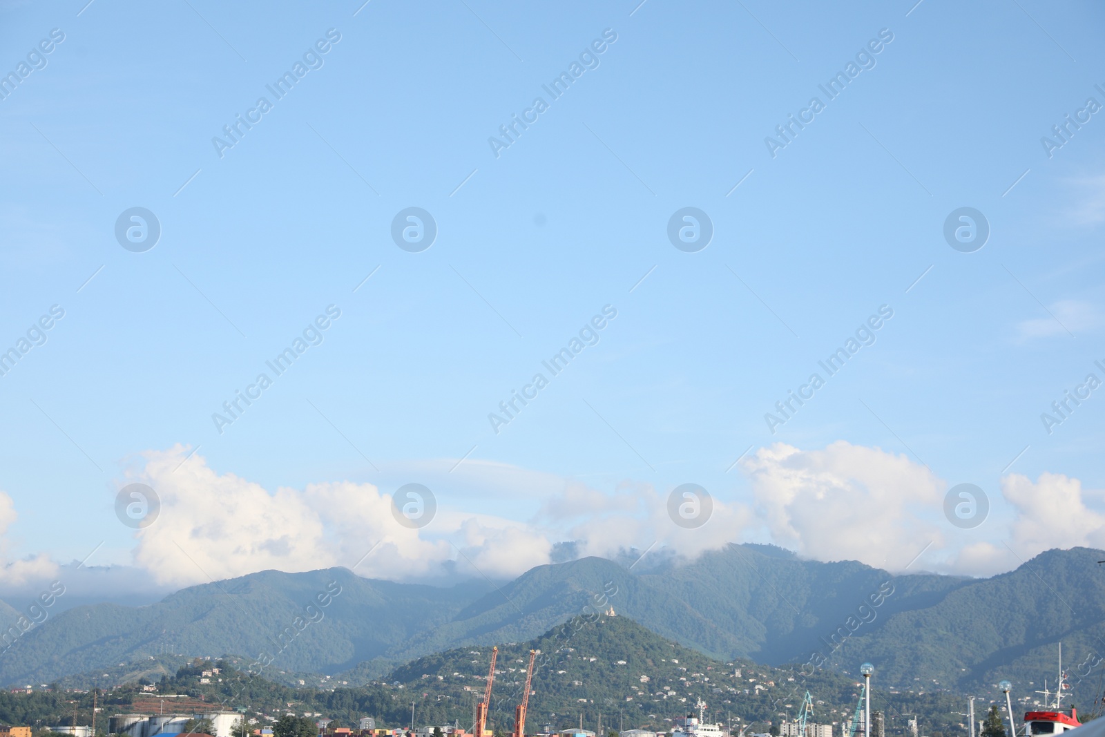 Photo of Picturesque view of modern city near mountains