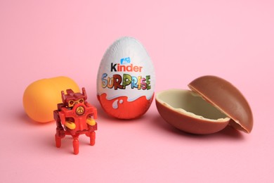 Sveti Vlas, Bulgaria - July 3, 2023: Kinder Surprise Eggs, plastic capsule and toy on pink background