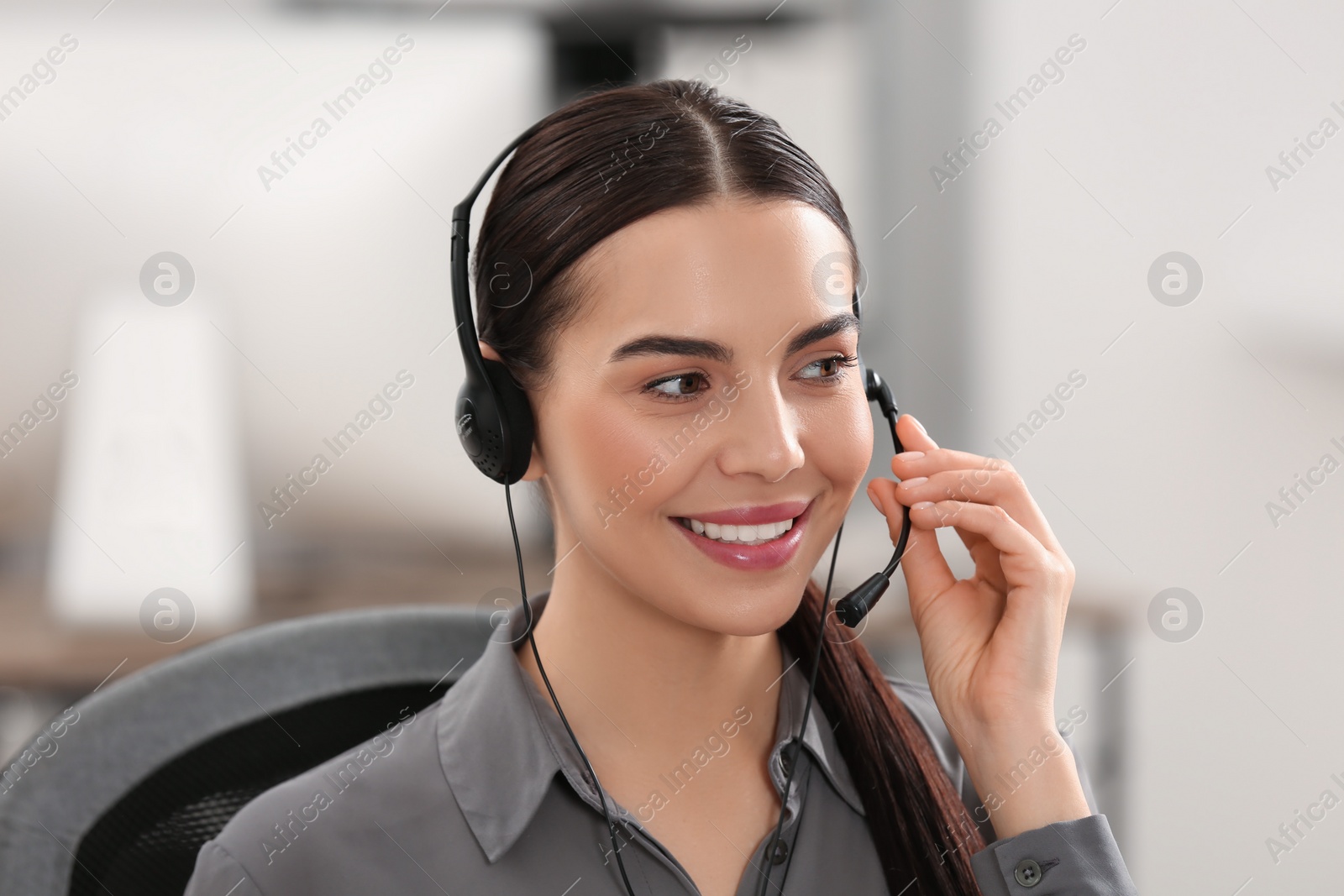 Photo of Hotline operator with headset working in office