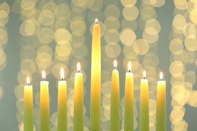 Hanukkah celebration. Burning candles against blurred lights