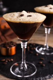 Photo of Glass of fresh cocktail with coffee beans, closeup