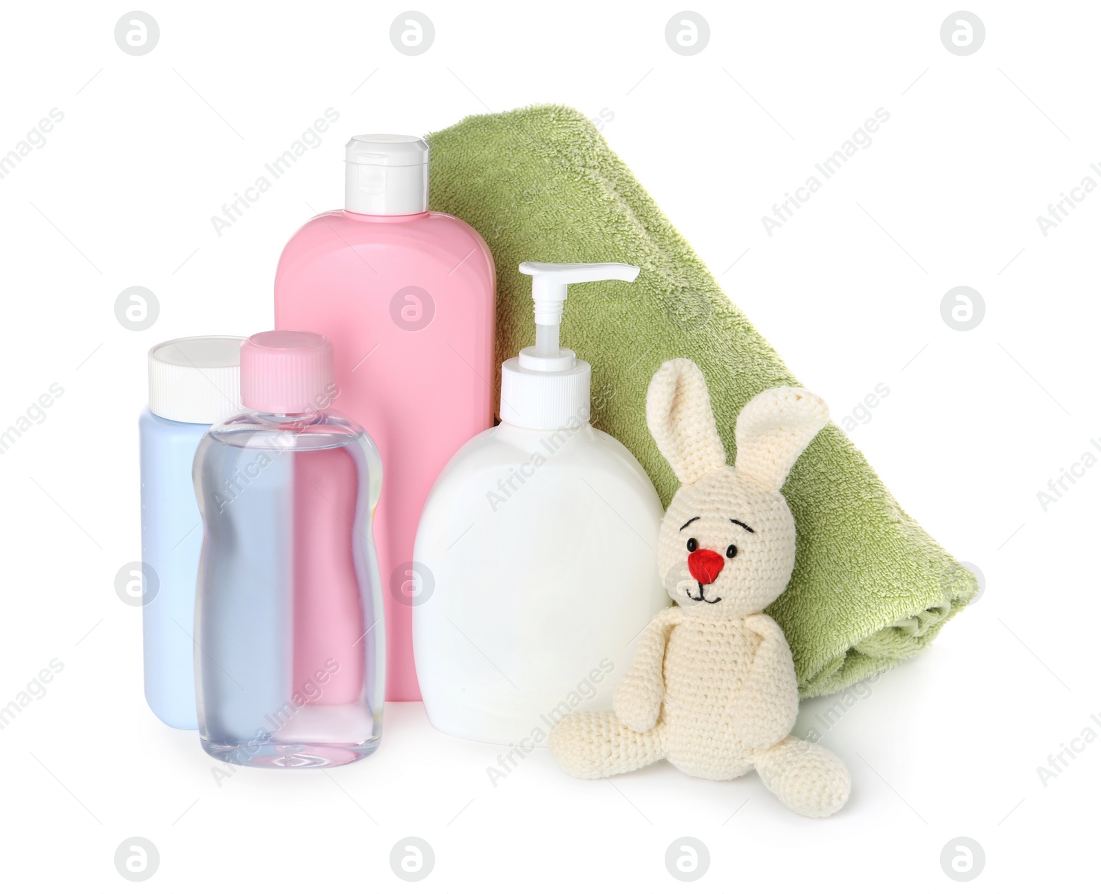 Photo of Bottles of baby cosmetic products, towel and toy bunny on white background