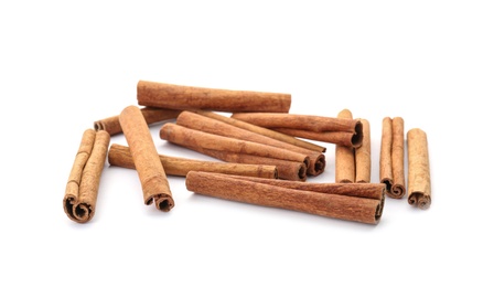 Photo of Aromatic cinnamon sticks on white background