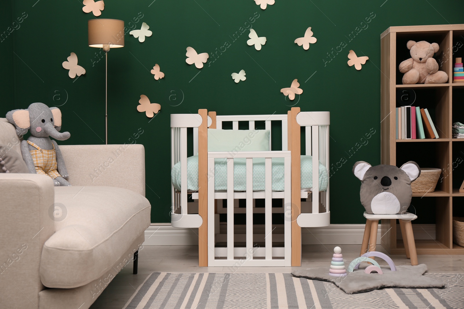 Photo of Beautiful baby room interior with stylish furniture and comfortable crib