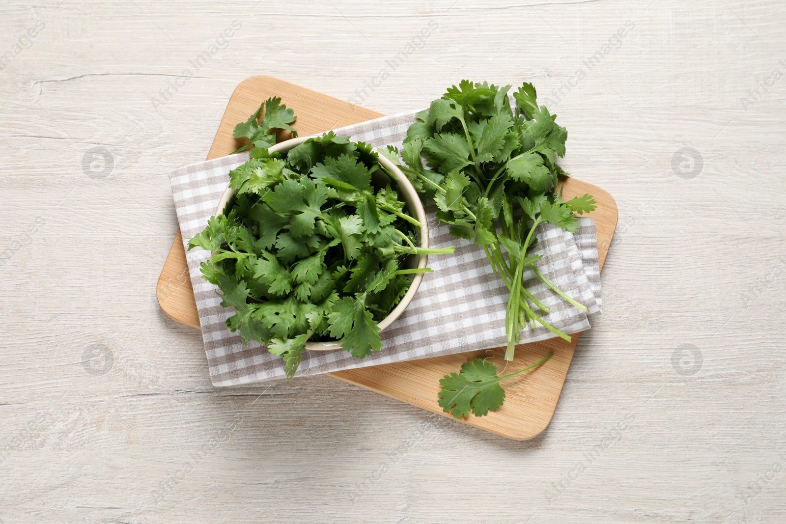 Photo of Bunch of fresh aromatic cilantro on white wooden table, top view