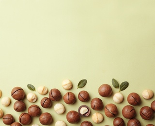 Photo of Composition with organic Macadamia nuts and space for text on color background, top view