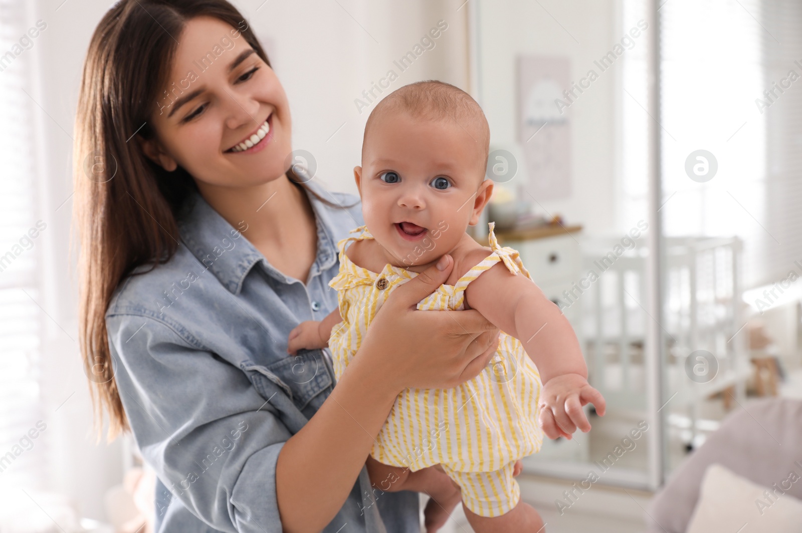 Photo of Happy young mother with her cute baby at home