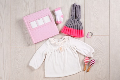 Photo of Flat lay composition with stylish child clothes and accessories on wooden background