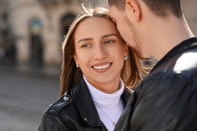 Photo of Lovely young couple enjoying time together outdoors, closeup. Romantic date