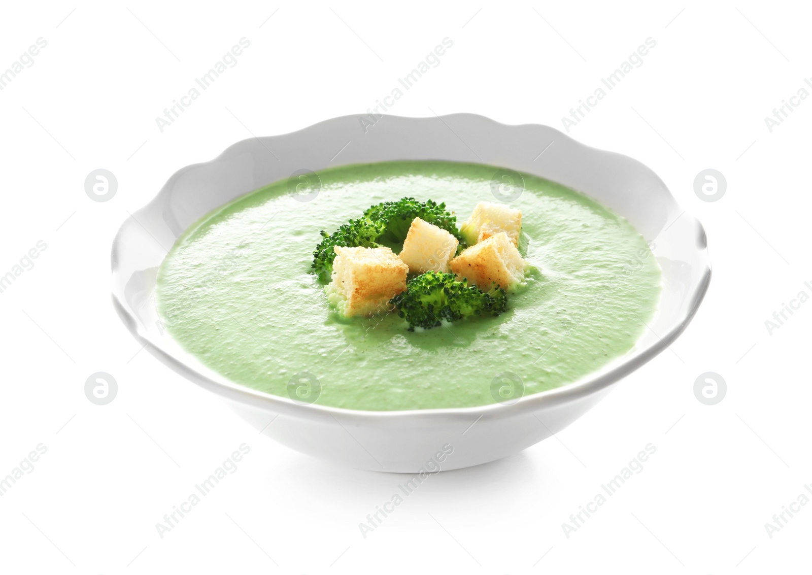 Photo of Fresh vegetable detox soup made of broccoli with croutons in dish on white background