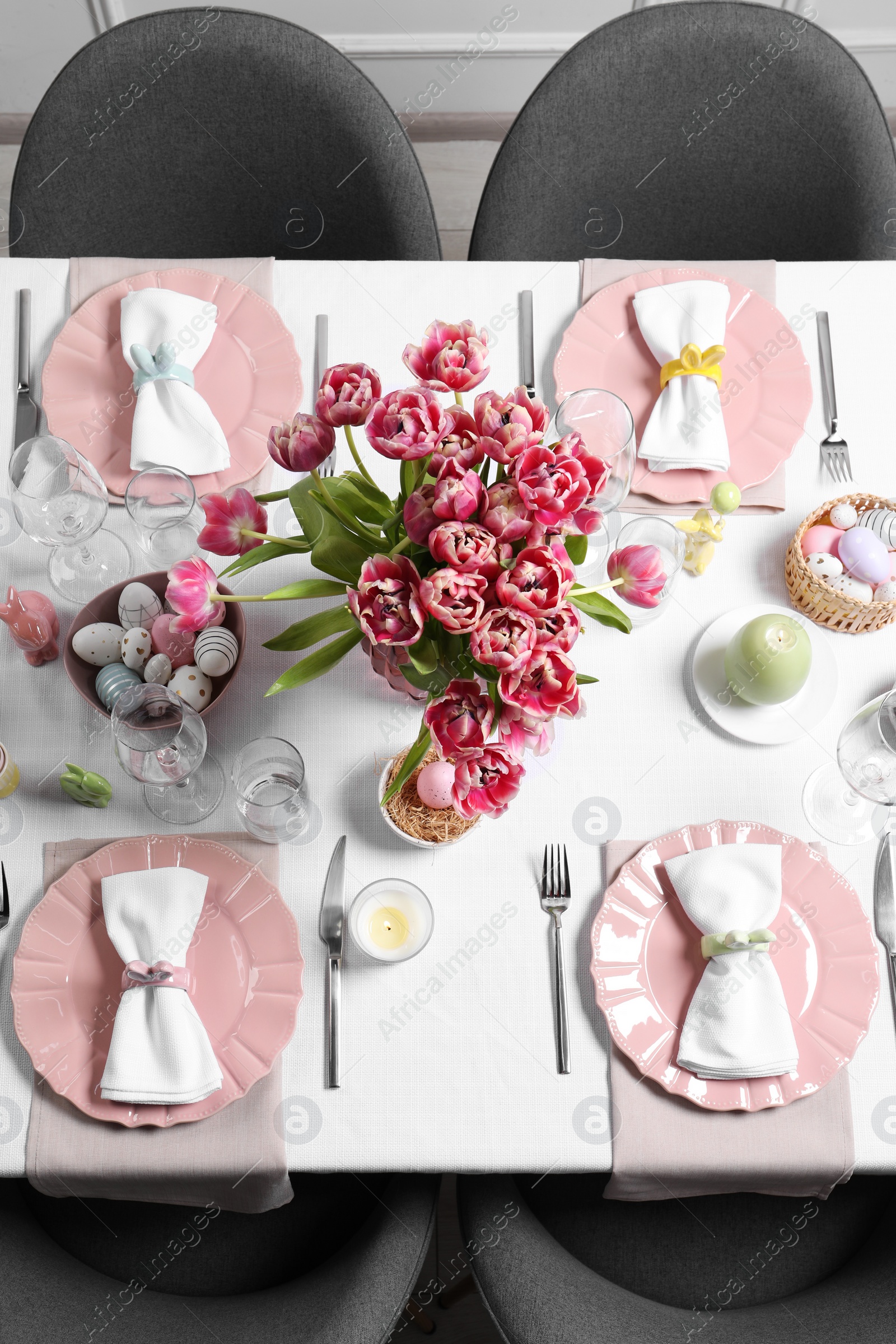 Photo of Festive table setting with beautiful flowers, top view. Easter celebration