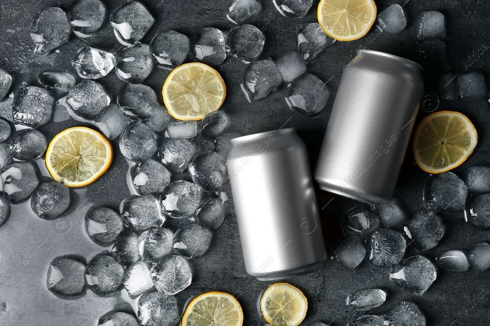 Photo of Flat lay composition with tin cans, lemon slices and ice cubes on dark background