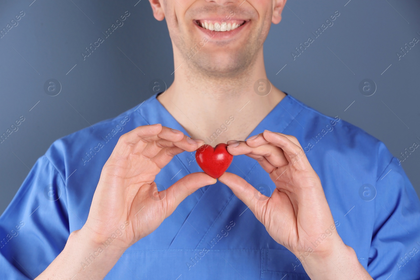 Photo of Doctor holding small heart, closeup. Prevent heart attack