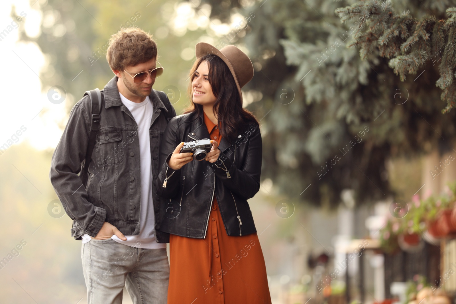 Photo of Couple of travelers with camera on city street