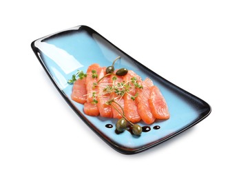 Photo of Delicious salmon carpaccio with capers, microgreens and sauce on white background