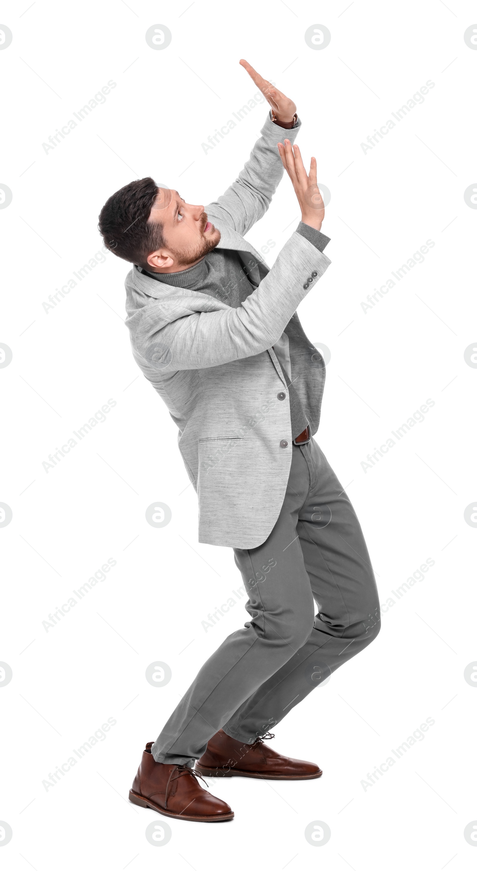 Photo of Emotional bearded businessman in suit evading something on white background