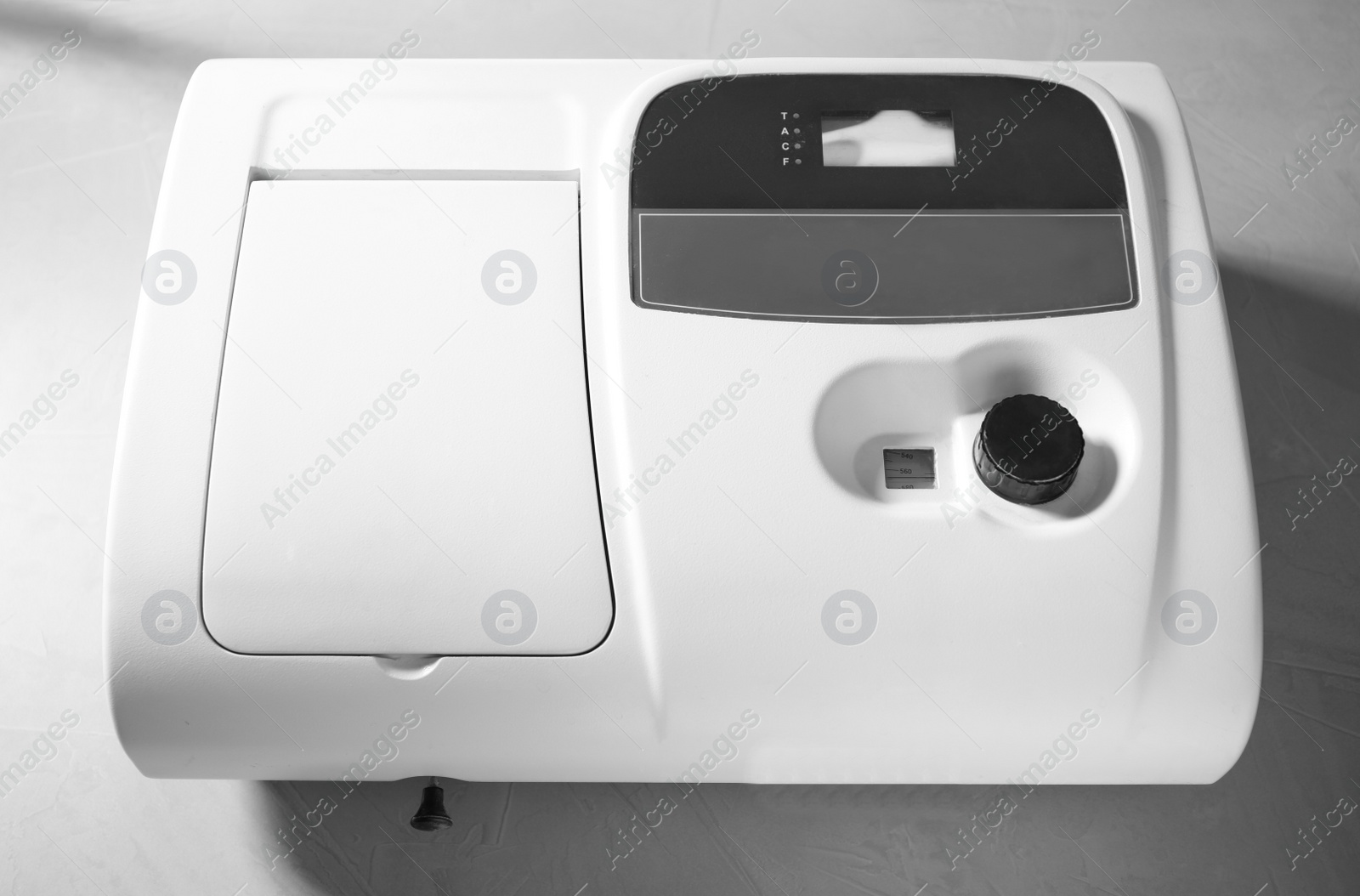 Photo of Spectrophotometer on grey table, top view. Laboratory research