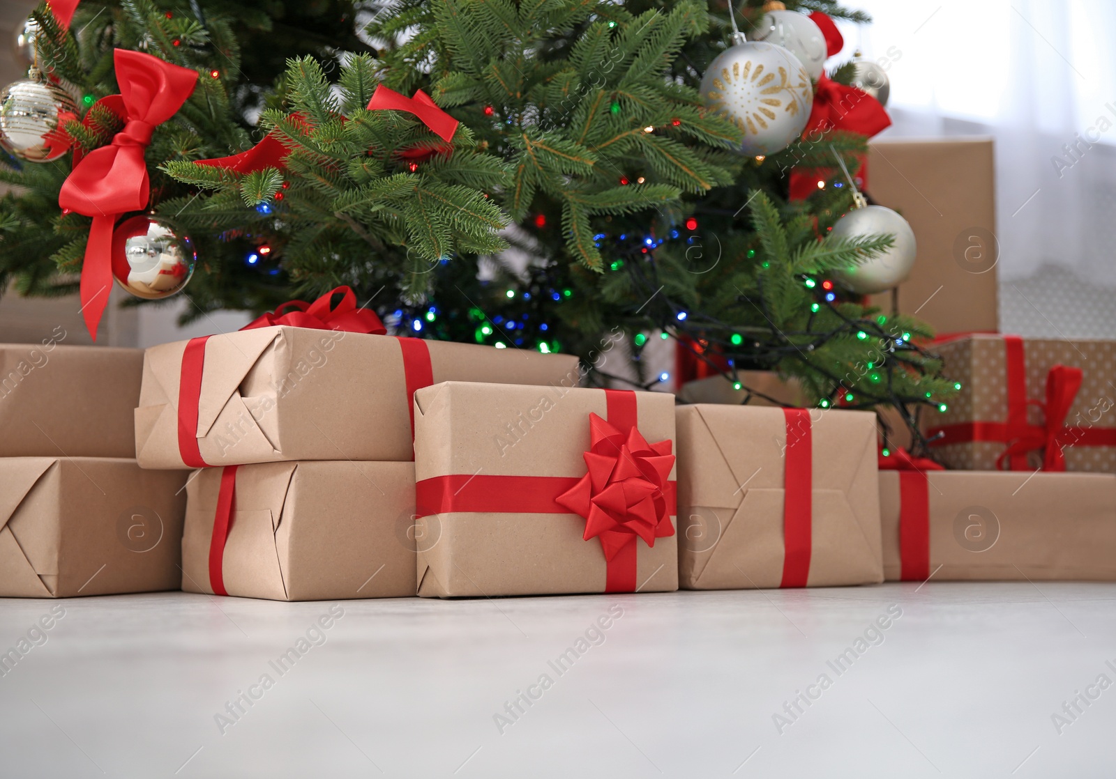 Photo of Beautiful Christmas tree with gift boxes indoors