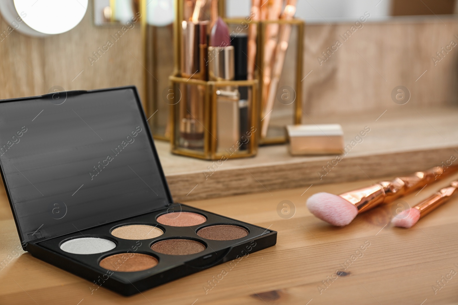 Photo of Cosmetic and brushes on dressing table in makeup room