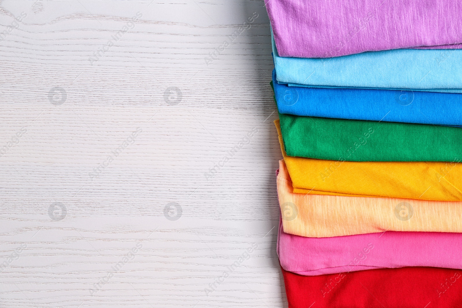 Photo of Colorful collection of  t-shirts on light background