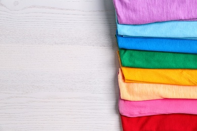 Photo of Colorful collection of  t-shirts on light background