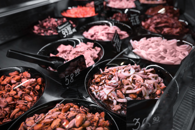 Photo of Different seafood on display, closeup. Wholesale market