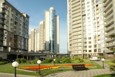Photo of KYIV, UKRAINE - MAY 21, 2019: Blurred view of modern housing estate in Pecherskyi district on sunny day