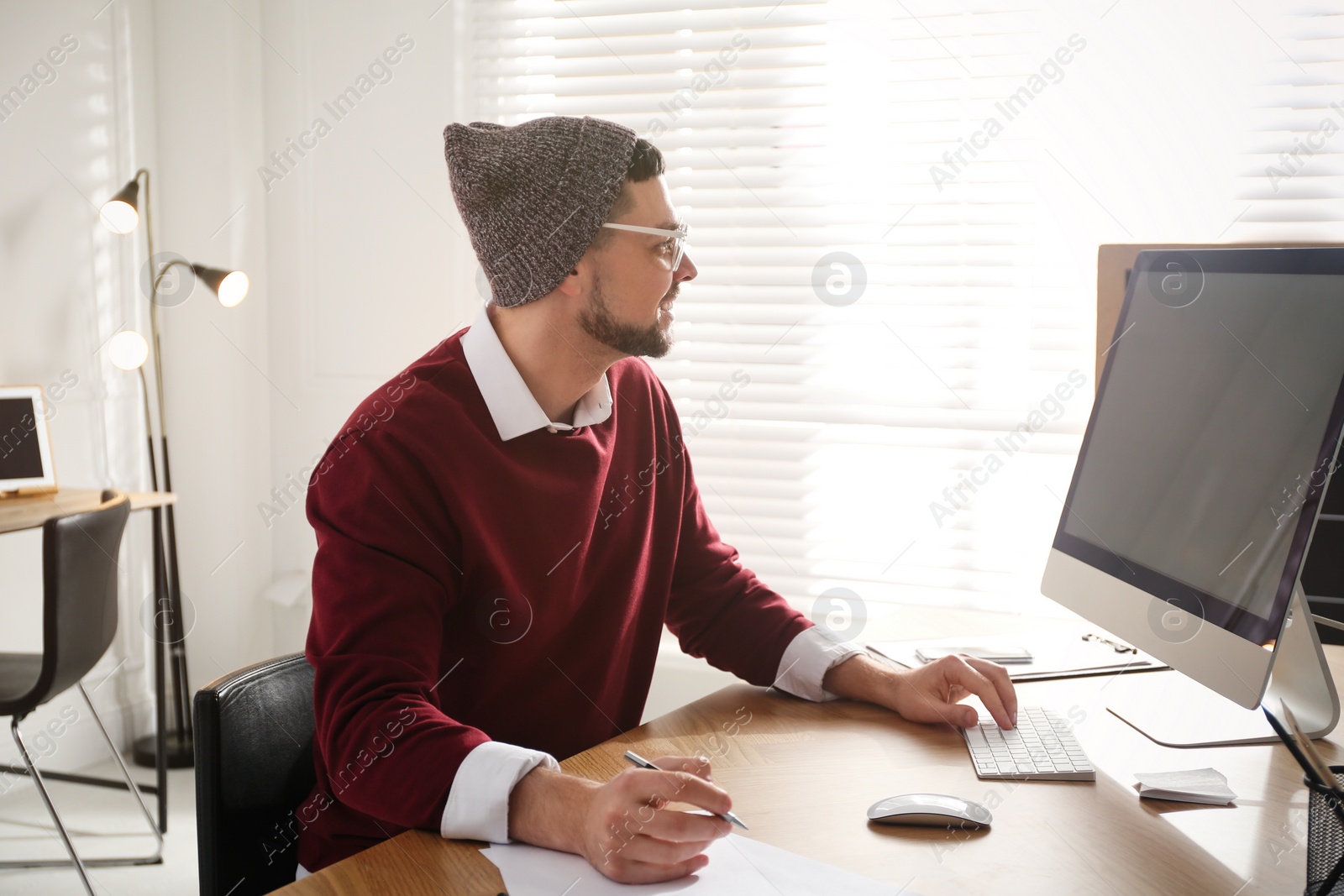 Photo of Freelancer working on computer at table indoors