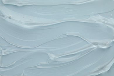 Photo of Clear cosmetic gel on light blue background, top view