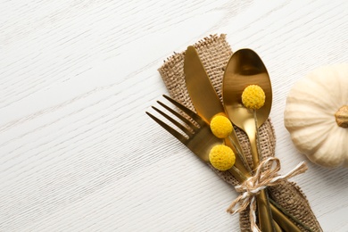 Photo of Top view cutlery decorated for autumn table setting and pumpkin on white wooden background, space for text