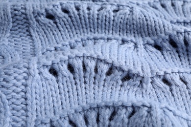 Blue knitted sweater as background, closeup view