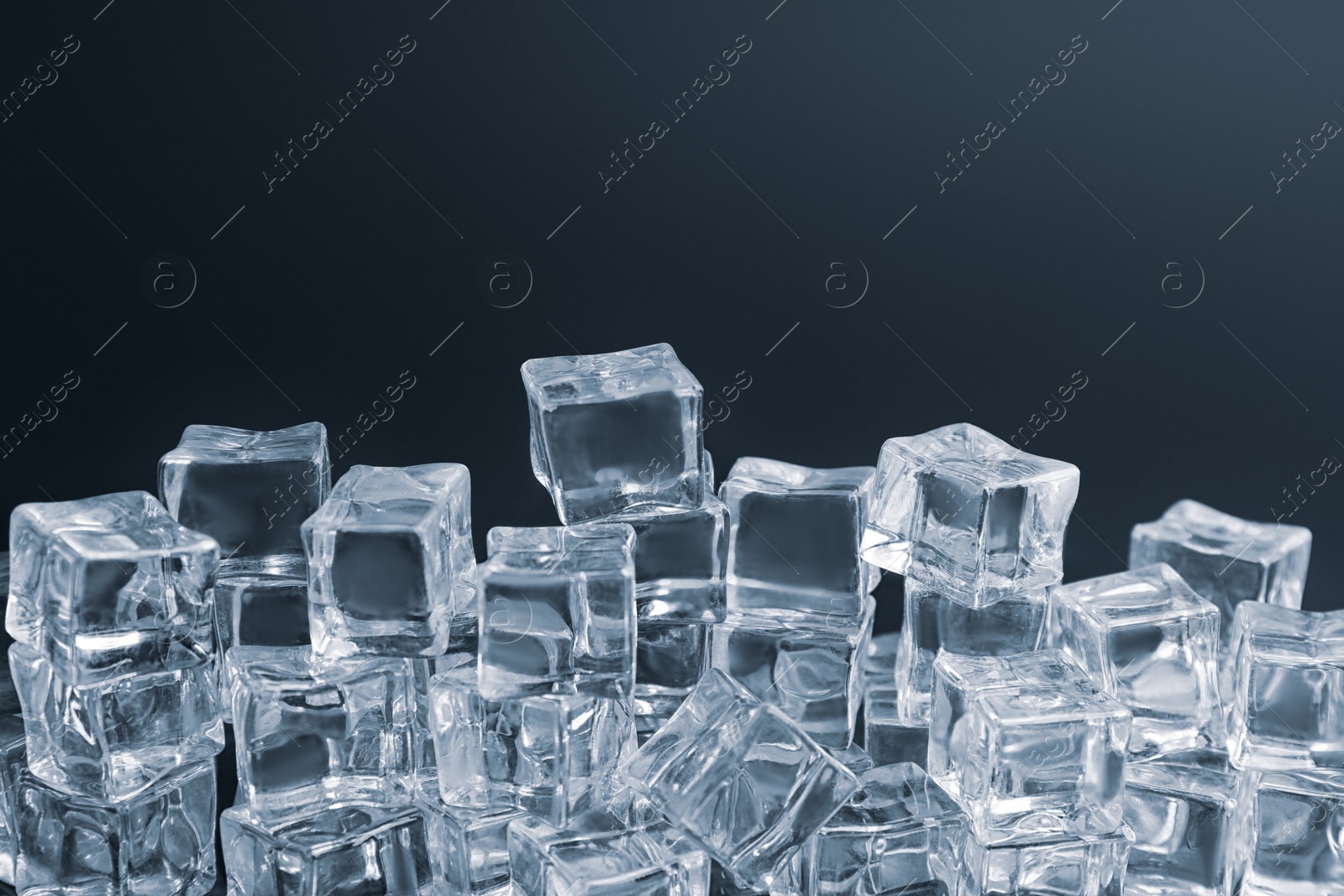 Photo of Crystal clear ice cubes on black background