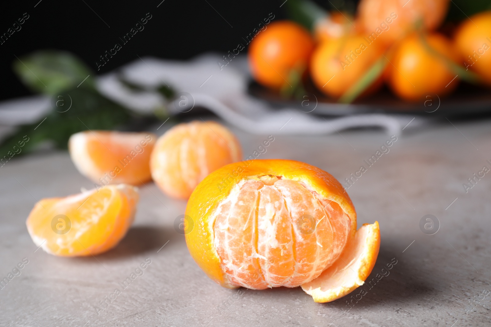 Photo of Fresh ripe tangerine on light grey table
