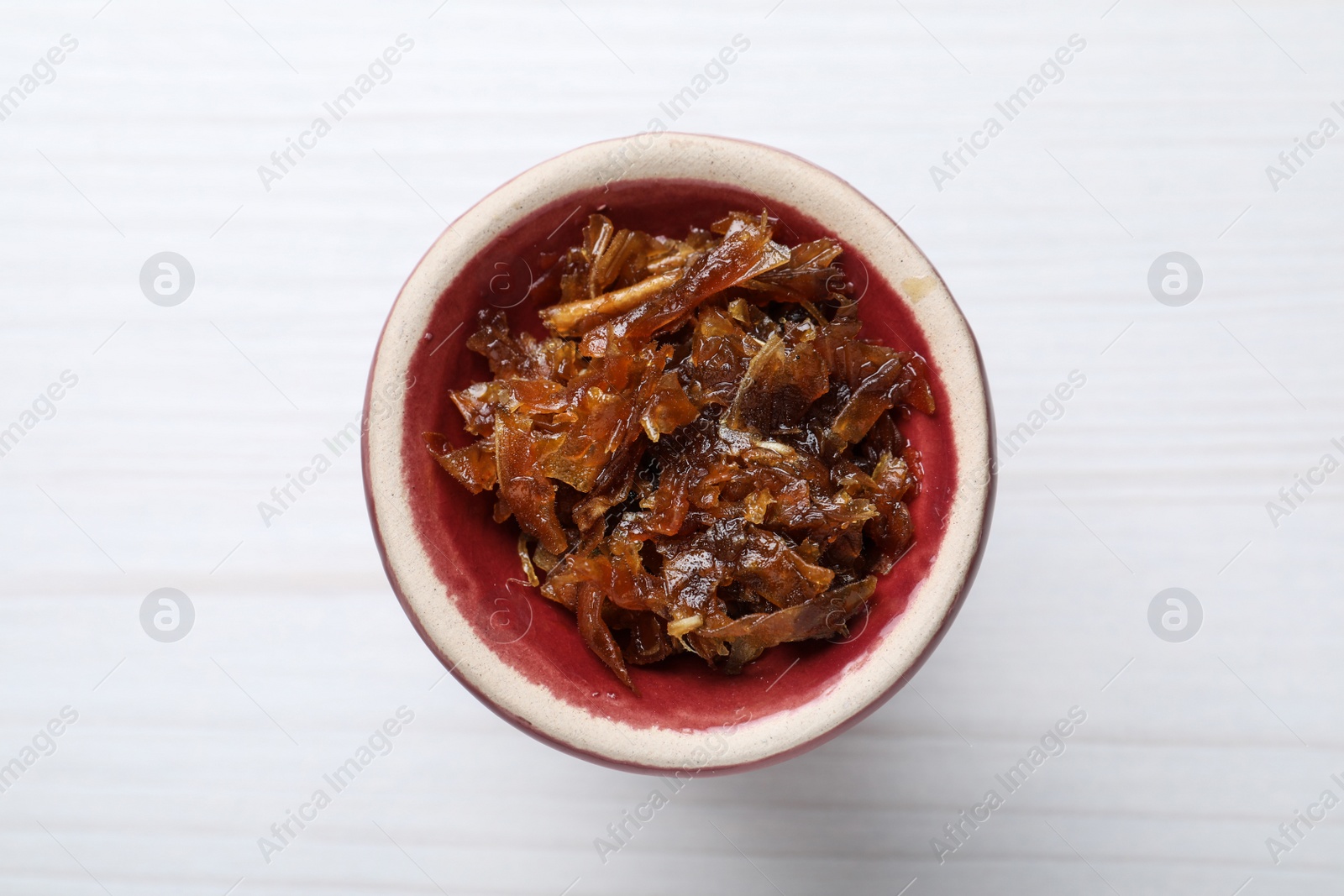 Photo of Modern hookah bowl with tobacco on white wooden table, top view