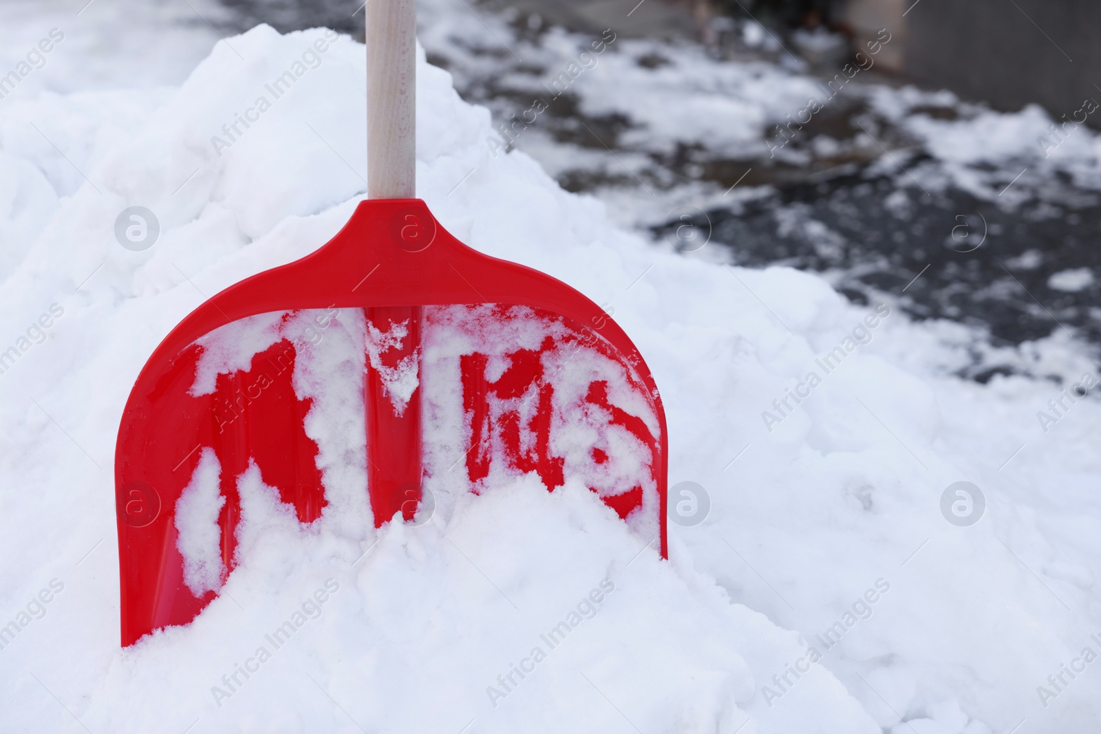 Photo of Snow shovel with wooden handle outdoors. Space for text