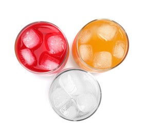 Photo of Glasses of different refreshing soda water with ice cubes on white background, top view