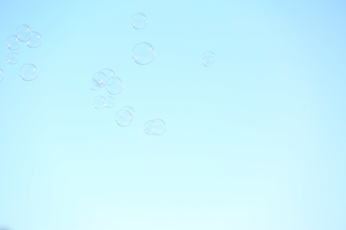 Beautiful translucent soap bubbles outdoors on sunny day. Space for text