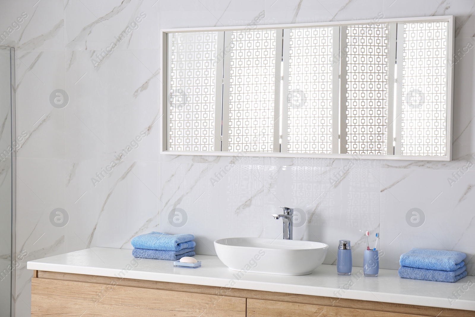 Photo of Modern mirror and vessel sink in stylish bathroom