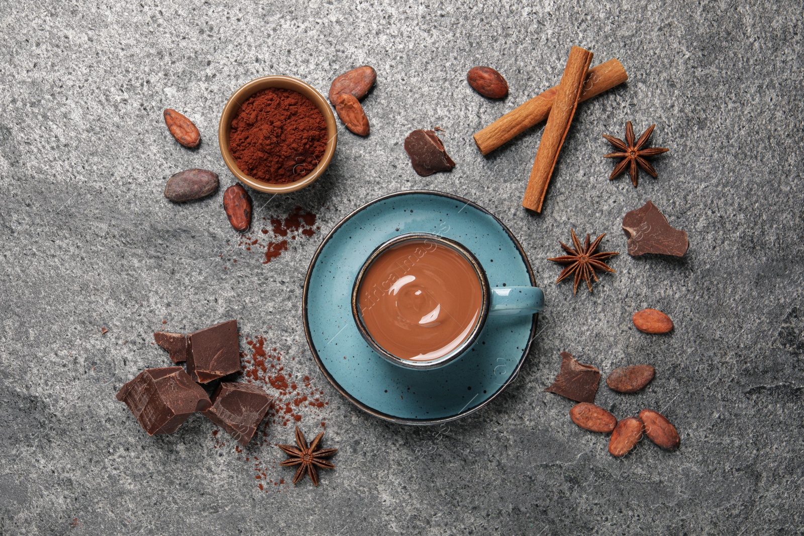 Photo of Flat lay composition with yummy hot chocolate on grey table