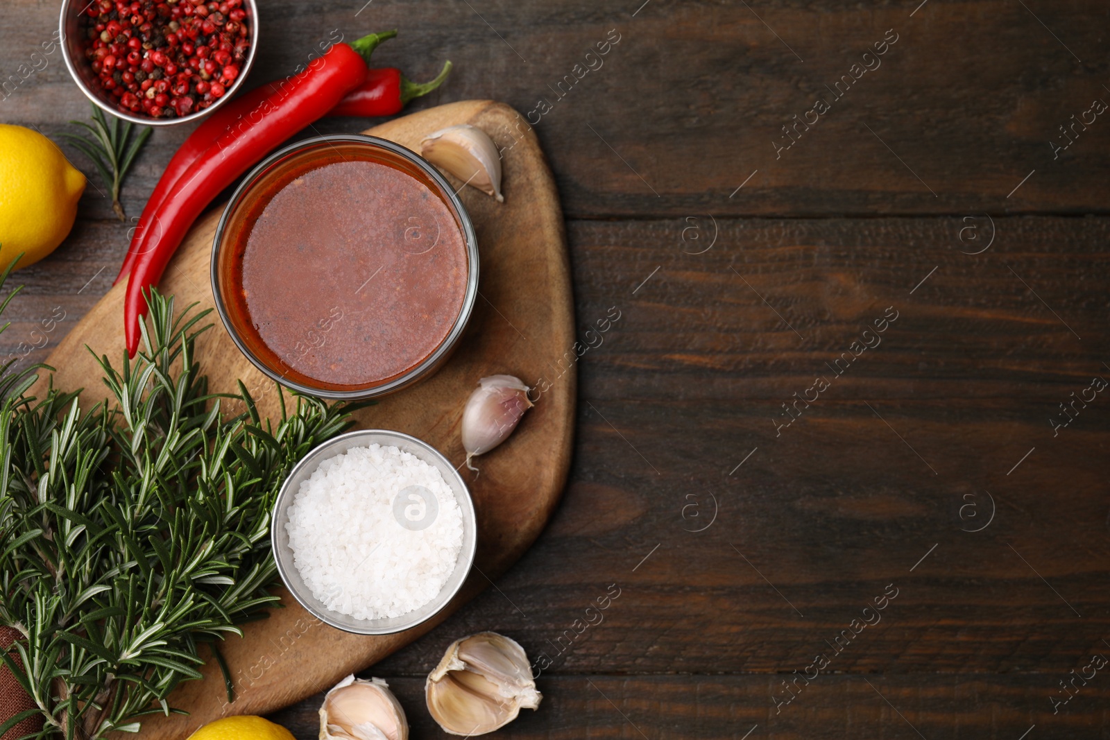 Photo of Fresh marinade and ingredients on wooden table, flat lay. Space for text