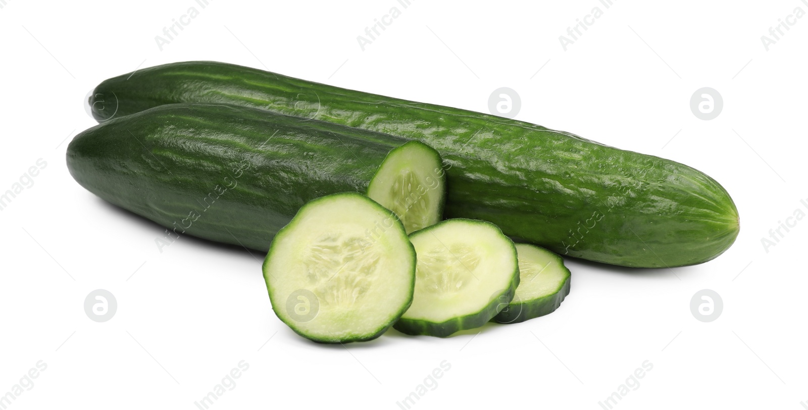 Photo of Whole and cut long cucumbers isolated on white