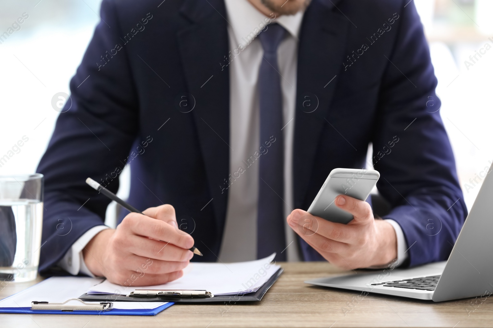 Photo of Consultant working at table in office