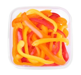Photo of Fresh cut bell peppers in plastic container isolated on white, top view