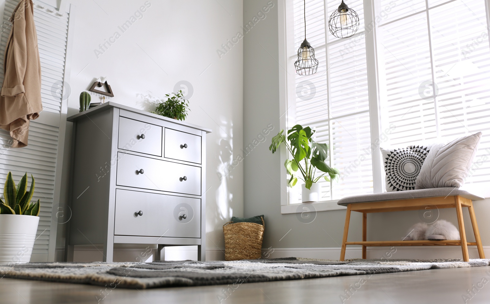 Photo of Grey chest of drawers in stylish room interior, low angle view