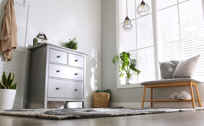 Photo of Grey chest of drawers in stylish room interior, low angle view