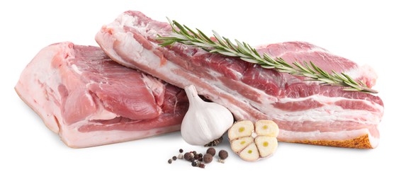 Photo of Pieces of raw pork belly, garlic, rosemary and peppercorns isolated on white