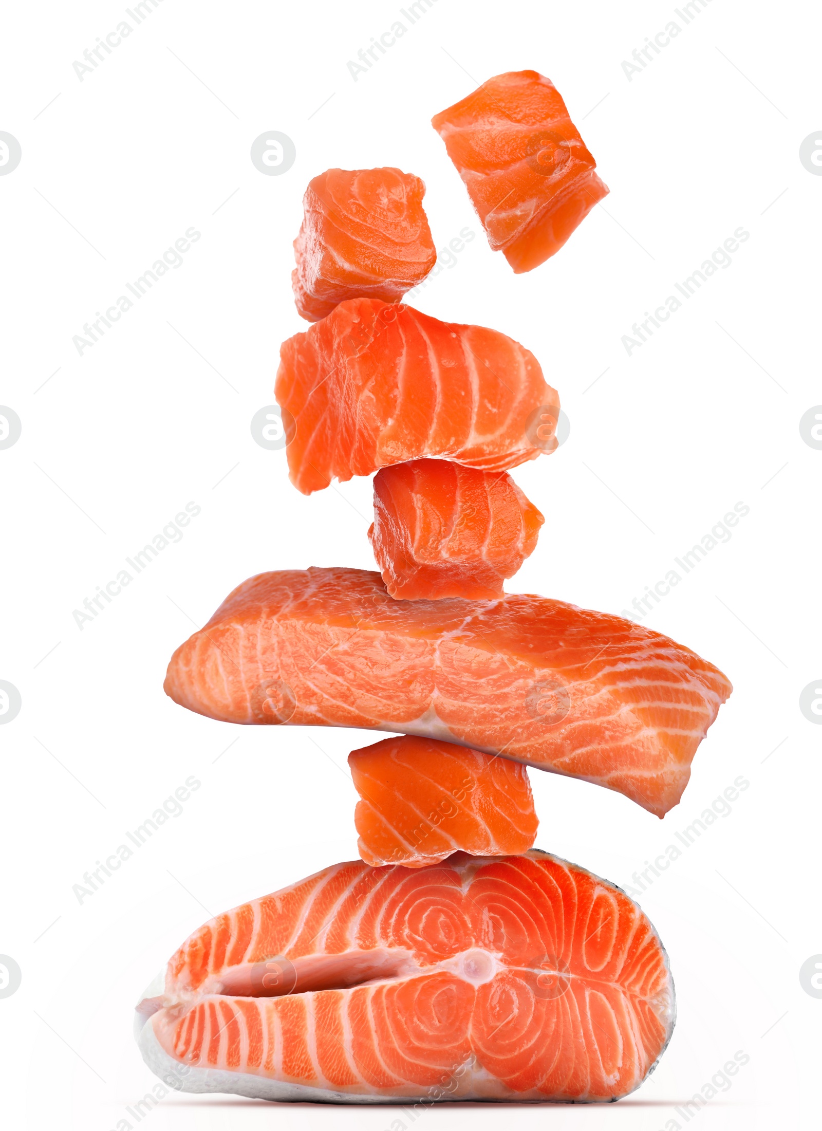 Image of Cut fresh salmon falling on white background