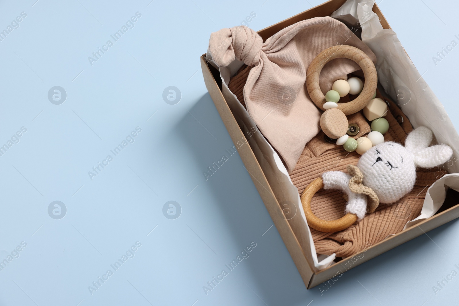 Photo of Different baby accessories in box on light blue background, above view. Space for text