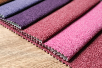 Photo of Fabric samples of different colors for interior design on table